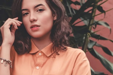 a woman in an orange shirt posing for a picture